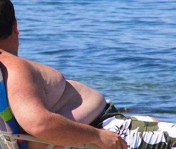 Fat-guy-laying-on-beach.jpg